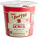 A red Bob's Red Mill container of gluten-free oatmeal with a white lid and label.