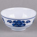A white melamine bowl with blue lotus flowers on it.