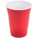 A close-up of a Solo red plastic cup with a white rim.