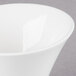 An Arcoroc white porcelain deep bowl with a small rim.