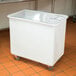 A white plastic container with a clear sliding lid.