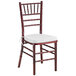 A Lancaster Table & Seating mahogany wood Chiavari chair with a white cushion.