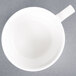 A CAC Collection bright white porcelain coffee cup with a handle.