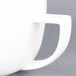 A close up of a CAC Collection bright white porcelain coffee cup with a handle.