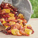 A Backyard Pro seafood boiler filled with crawfish and corn on a table in an outdoor catering setup.