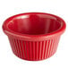 A red fluted Acopa melamine ramekin with a white background.