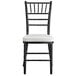 A Lancaster Table & Seating black Chiavari chair with ivory cushion.