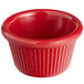 A red fluted melamine ramekin with a white background.
