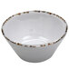 A white ramekin with brown speckled spots.
