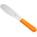 A Choice stainless steel sandwich spreader with a neon orange handle.