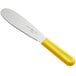 A Choice stainless steel sandwich spreader with a yellow handle.