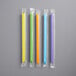 A group of six neon boba straws in plastic wrappers.