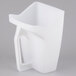 A white plastic wall mount container with a handle holding a utility scoop.