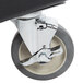 A black and white wheel with a chrome center on a Cambro Camdolly.