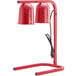 A red metal Avantco free standing heat lamp with two red bulbs.