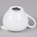 A white porcelain creamer with a handle and a lid.