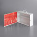 A white metal box with a red pocket organizer inside.