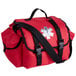 A red Medique trauma bag with black straps and white symbols.