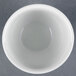 A white CAC China egg cup on a grey surface.