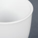 A close up of a white CAC China egg cup.