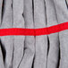A close up of a red and gray striped Unger SmartColor microfiber tube mop head.
