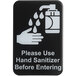 A black and white Tablecraft plastic sign with the words "Please Use Hand Sanitizer Before Entering" and a symbol of a hand with sanitizer.