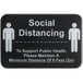 A black Tablecraft sign with white text reading "Social Distancing" and people icons.