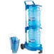 A blue plastic San Jamar ice tote with two plastic containers inside and a cart.