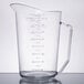 A Cambro clear polycarbonate measuring cup with numbers and a handle.
