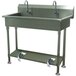 An Advance Tabco stainless steel multi-station hand sink with two toe-operated faucets.