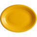An oval mango orange stoneware plate with a rim on it.