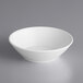 An Acopa Liana bright white porcelain bowl with embossed lines on the rim.