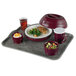 A Cambro room service tray with a plate of food, bowl of vegetables, and bowl of rice pudding with fruit on a table.