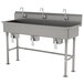 An Advance Tabco stainless steel multi-station hand sink with faucets.