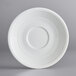 An Acopa Capri coconut white china saucer with a circular pattern on a white background.