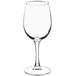 An Acopa Select Flora wine glass filled with white wine on a white background.