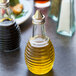 A Tablecraft beehive oil and vinegar dispenser bottle with a stainless steel top.