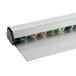 A Choice aluminum wall mounted ticket holder with marbles inside.