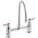 A silver Waterloo deck mount faucet with two red knobs.
