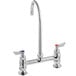 A chrome Waterloo deck mount faucet with 8" gooseneck spout and red and silver knobs.