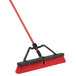 A red Libman multi-surface push broom with a black and red handle.