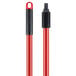 A red and black Libman push broom with a black handle.
