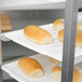 A Winholt white polystyrene display tray holding loaves of bread.
