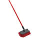 A red Libman dual surface scrub brush with a long handle.