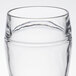 A close up of a clear Stolzle beer boot glass with a rim.
