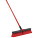 A red and black Libman Multi-Surface Push Broom with a handle.