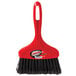 A red Libman whisk broom with black bristles and a black handle.