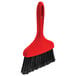 A red Libman whisk broom with black bristles.
