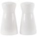 Two white ceramic tower salt and pepper shakers.