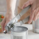 A person using a Choice Manual Can Opener with a gray handle to open a can.